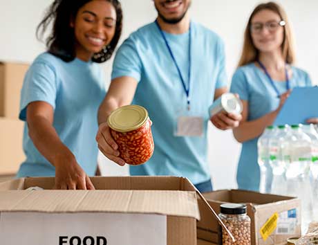 group of people loading food in boxes