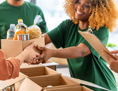 group of people loading food in boxes